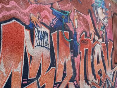 Orange lettering and shouting characters — Street art in Marseille