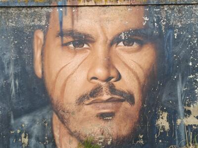 Hyperrealistic portrait with a moustache — Street art by Jorit in Lisboa