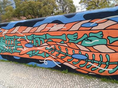 Orange skeleton fish — Street art by Mariana Rio in Lisboa