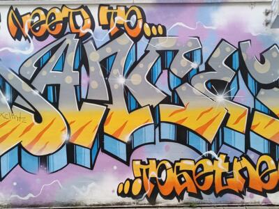 We need to... together, lettering in flames — Street art in Köln