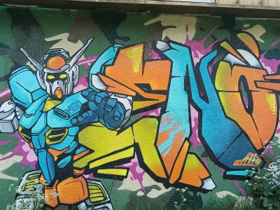 Gundam Robot with Orange Piece — Street art in Sainte-Luce-sur-Loire
