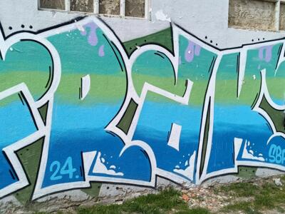 Blue and Green Lettering with Oki Cap Character — Street art in Almada