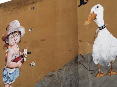 The Girl with the Duck — Street art by El Rojo in La Bañeza