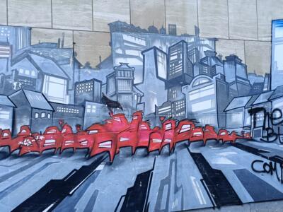 The Red Crowd Crossing the Grey City — Street art in Bruxelles