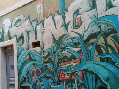 White lettering among agaves, Rue Baussenque — Street art in Marseille