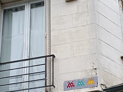 Trio of red, green and yellow Invaders — Street art by Invader in Paris