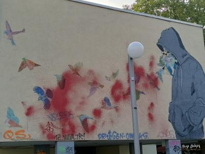 Hooded Figure with Birds at Mehringplatz — Street art in Berlin