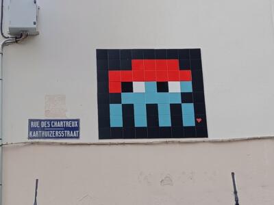 Red and Cyan Space Invader on Rue des Chartreux — Street art by Invader in Bruxelles