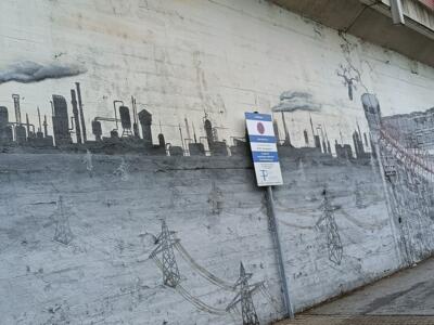 Industrial skyline and a crowd in line — Street art in Köln