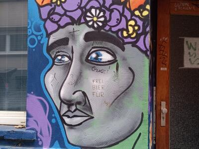Visage gris à la couronne de fleurs — Street art à Köln