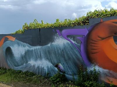 Wave and giant orange fish — Street art in Yffiniac