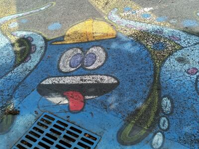 Blue octopus painted on the road — Street art in Yffiniac