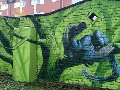 Blue macaw in painted foliage — Street art by Colorrevolution e.V. in Köln