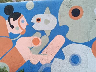 Swimmer with a bun among the fish — Street art by Mariana Rio in Lisboa