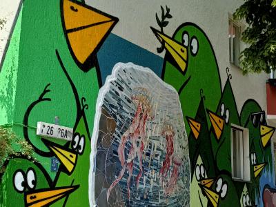 Green Bird Invasion on the Corner — Street art in Berlin