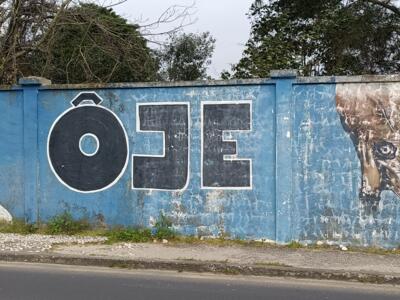 Old man in a beanie and a plant figure — Street art by ÔJE in Lisboa