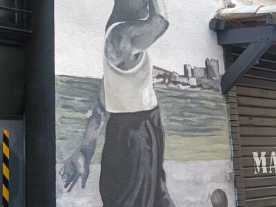 Walker in a tank top before the tall ship — Street art in Marseille