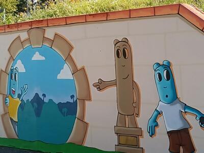 Little characters and round gateway — Street art by Les Oides in Yffiniac
