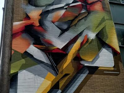Faceted abstraction in grey and orange — Street art by Does in Ixelles