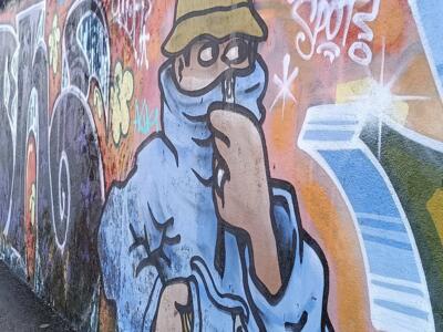 Figure in a Bucket Hat and Hood by Komo — Street art in Lisboa
