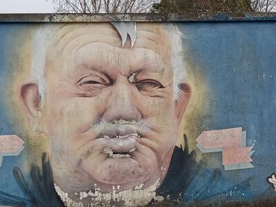 Old man with puffed cheeks — Street art in Lisboa