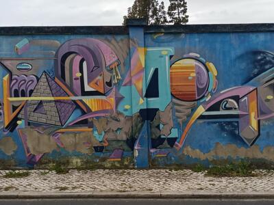Pyramid and orange planet — Street art by Odeith in Lisboa