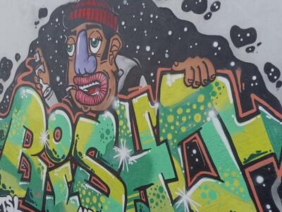 Green and Yellow Lettering with Beanie Man — Street art by Bisho in Almada