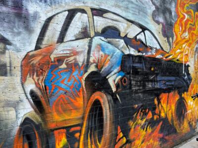 Voiture en flammes sur brique blanche — Street art à London