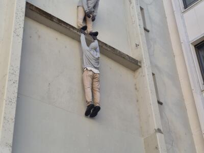 Two hooded climbers on a facade — Street art in Basel