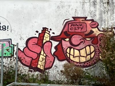 “Pink City” character with a brick chimney — Street art in Perros-Guirec