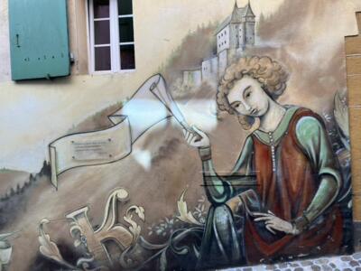 Figure with a Scroll before the Castle — Street art in Neuchâtel