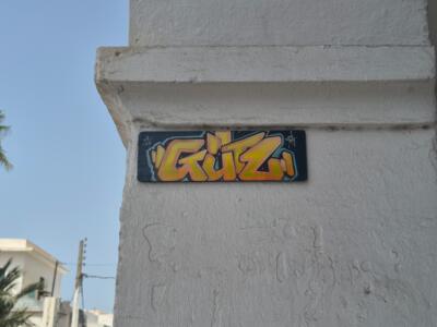 GUTZ lettering on a board — Street art in Houmt Souk