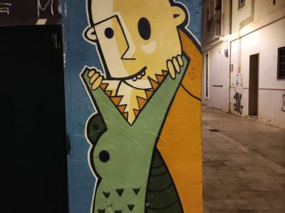 Yellow Character in a Scaled Coat — Street art by LEMAT in València