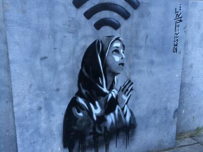 La priante à l'auréole Wi-Fi — Street art de EZKSTREETART à Bruxelles
