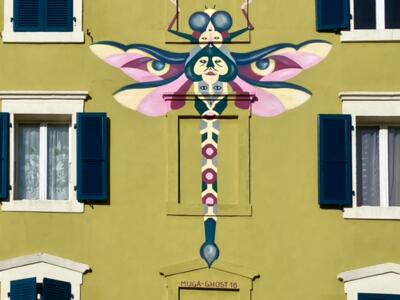 Dragonfly of Stacked Faces — Street art in La Chaux-de-Fonds
