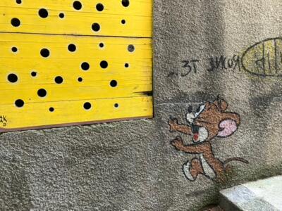 Jerry and his slice of Emmental — Street art by OakOak in Le Locle