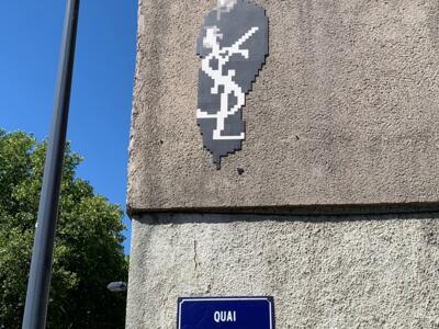 Yves Saint Laurent on Quai Saint-Laurent — Street art by Mifamosa in Orléans