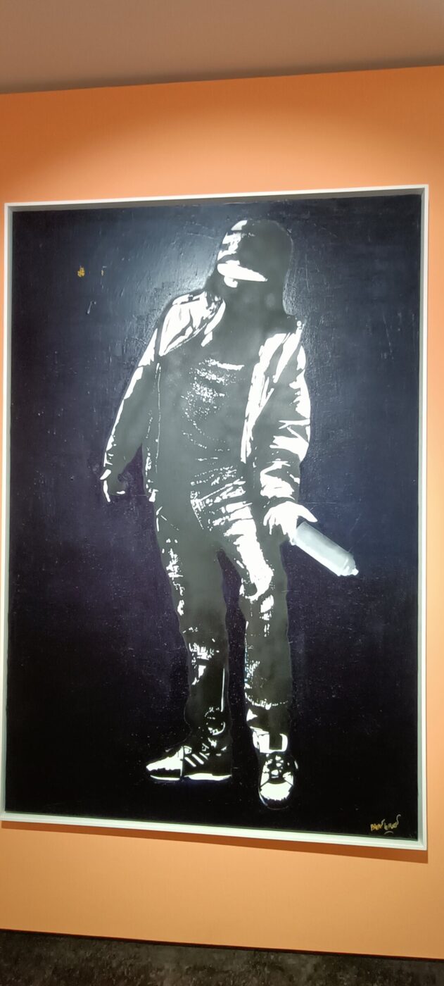 A canvas by Blek le Rat: a writer, a spray can, and the little rat that serves as a signature.