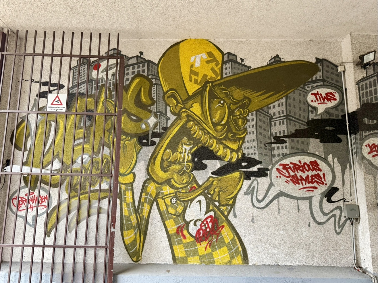 Yellow Can Red Lettering Yellow character in a cap: graffiti in Riga